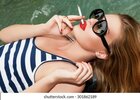 girl-glasses-by-pool-cigarette-260nw-301862189.jpg