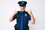 young-caucasian-man-wearing-police-uniform-angry-mad-raising-fists-frustrated-furious-shouting...jpg